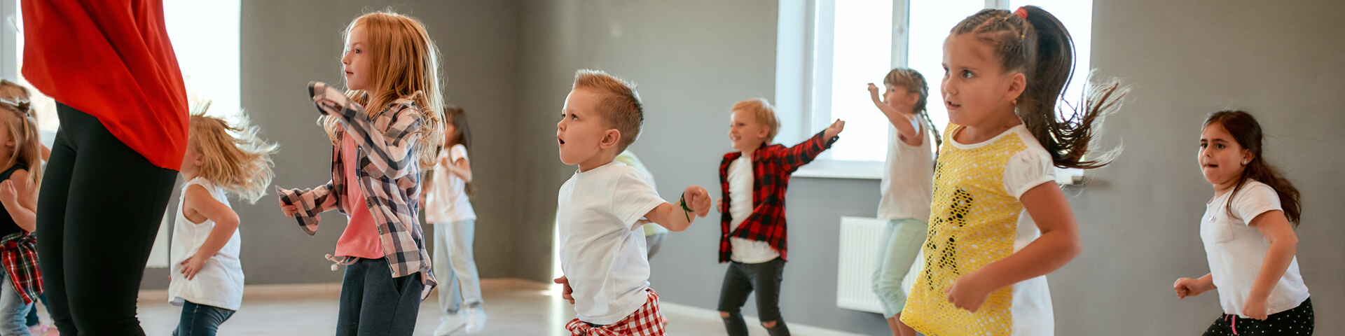 Children in a dance class, Following teacher’s dance moves.